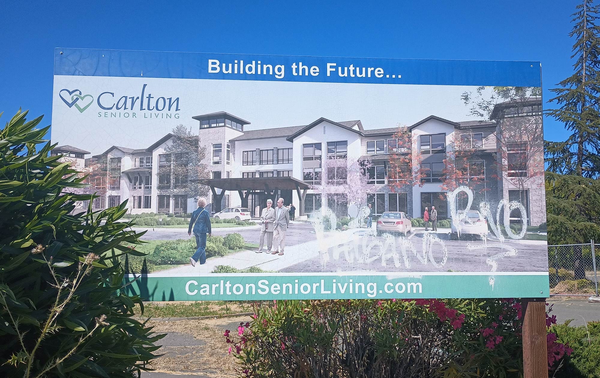 A billboard for a long promised Carlton Senior Living development at the former Elks Lodge on Redwood Street. 