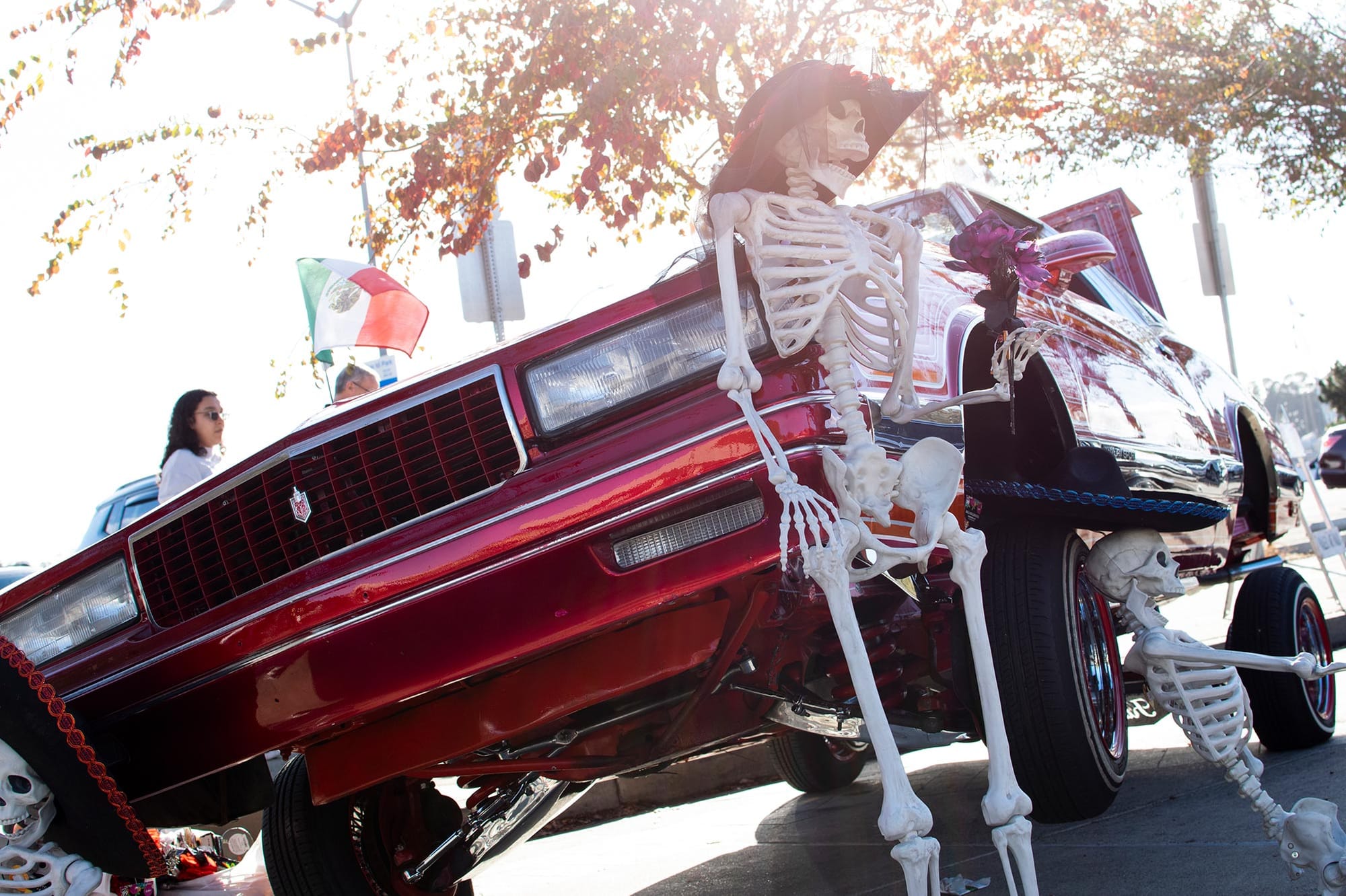 A decorated car in the classic car show during the Dia De Los Muertos festival.