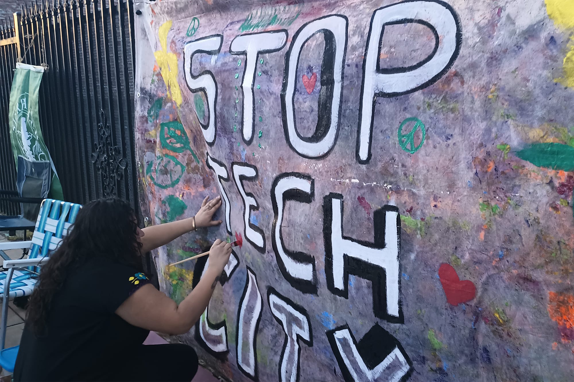 A protester paints a "Stop Tech City" banner outside of California Forever's offices in Vallejo during Friday's Art Walk event. Photo: Gretchen Zimmermann.